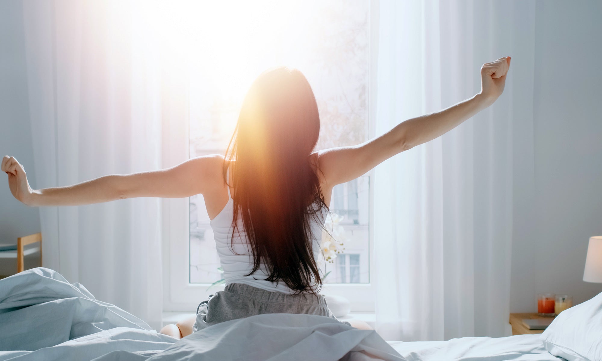 Woman just woke up with a good stretch to get ready or morning workout