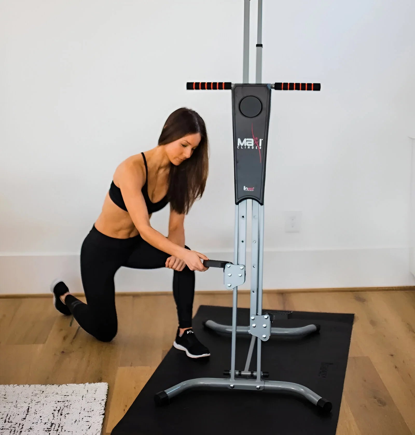 Woman placing the MaxiClimber 2.0 machine in a space in her home.